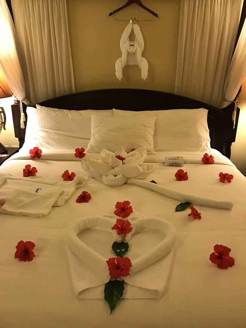 Bed decorated with flowers, balloons and towel art by our butler during an earlier Sandals Negril stay.